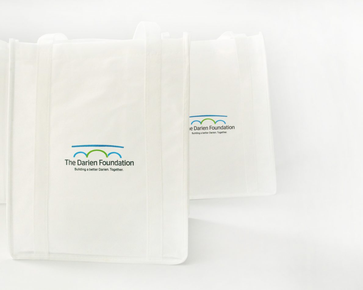 Tote bags featuring the new logo.